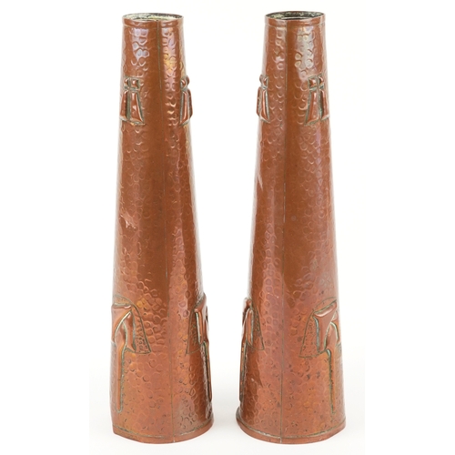 13 - A pair of Arts & Crafts copper conical vases embossed with stylized motifs, 27cm high.