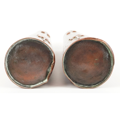 13 - A pair of Arts & Crafts copper conical vases embossed with stylized motifs, 27cm high.