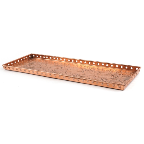 12 - An Arts & Crafts rectangular copper gallery tray embossed with stylized foliage, 55cm x 20.5cm.