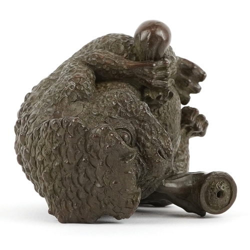 172 - A Japanese patinated bronze study of a seated toad smoking a pipe, impressed character marks to the ... 