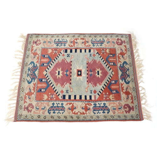 1169 - A Turkish rug, 20th century, the pink field with stylized central medallion within a complementary b... 