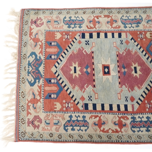 1169 - A Turkish rug, 20th century, the pink field with stylized central medallion within a complementary b... 