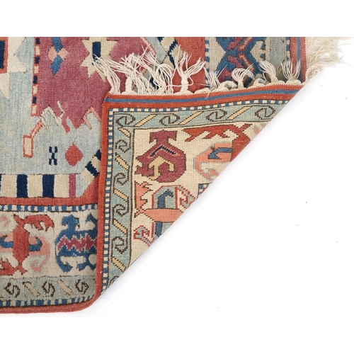 1169 - A Turkish rug, 20th century, the pink field with stylized central medallion within a complementary b... 