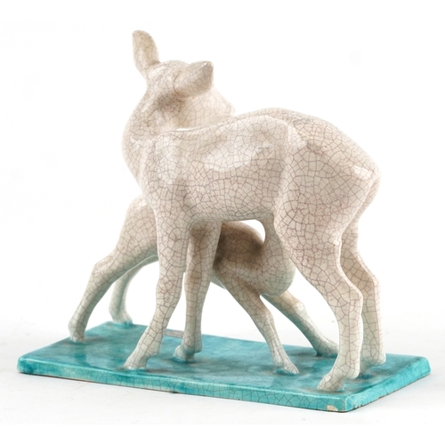 22 - A Goldscheider Art Deco pottery study of a fawn and deer, marks and sticker to the base, 16cm high.