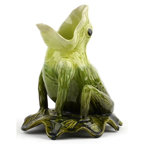 144 - An early 20th century Majolica jug modelled as a frog sitting on a lily pad, probably Bretby, 21cm h... 