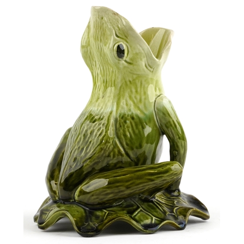 144 - An early 20th century Majolica jug modelled as a frog sitting on a lily pad, probably Bretby, 21cm h... 