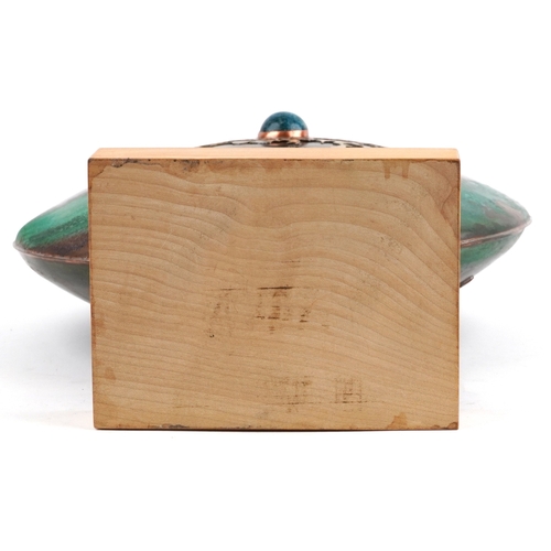 1 - Sam Fanaroff, an Arts & Crafts style copper shield vase having a green stone cabochon, raised on a l... 