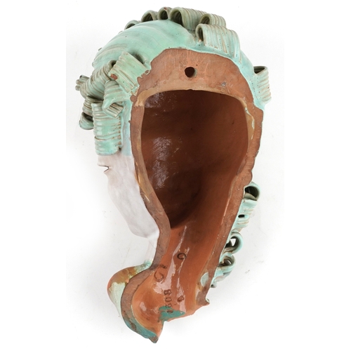 24 - A Goldscheider Art Deco terracotta female wall mask numbered 7608, 30cm high.