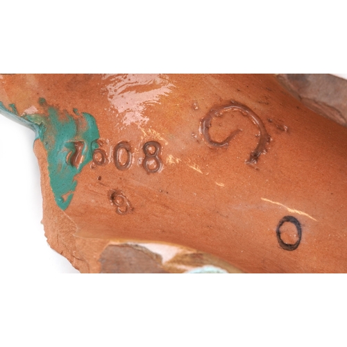 24 - A Goldscheider Art Deco terracotta female wall mask numbered 7608, 30cm high.