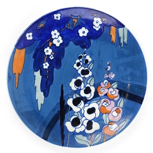 278 - Charlotte Rhead for Wood & Sons, an Art Deco pottery charger hand painted with stylized flowers, num... 