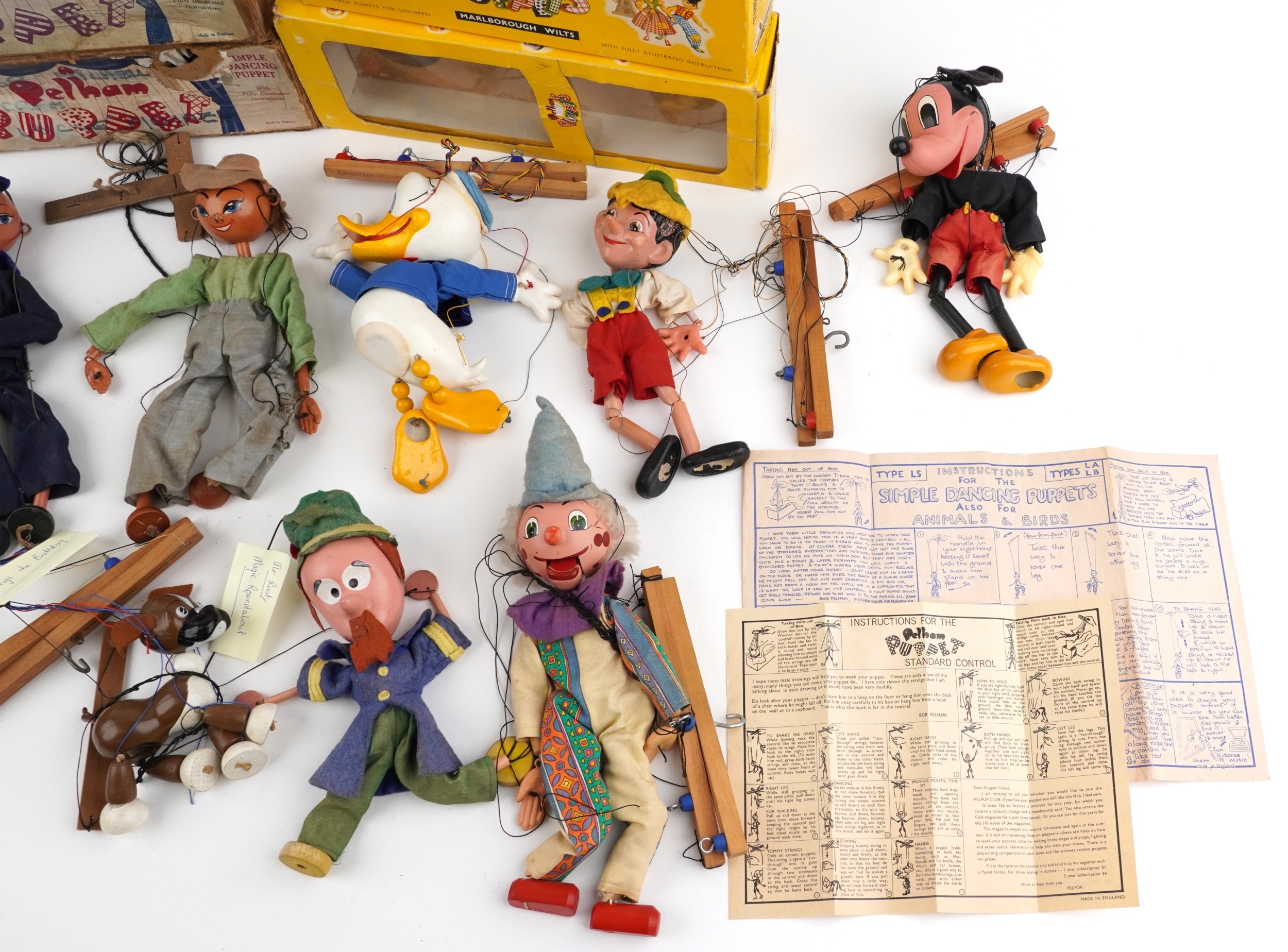 Seven Pelham puppets including Donald Duck, Pinocchio and a sailor ...