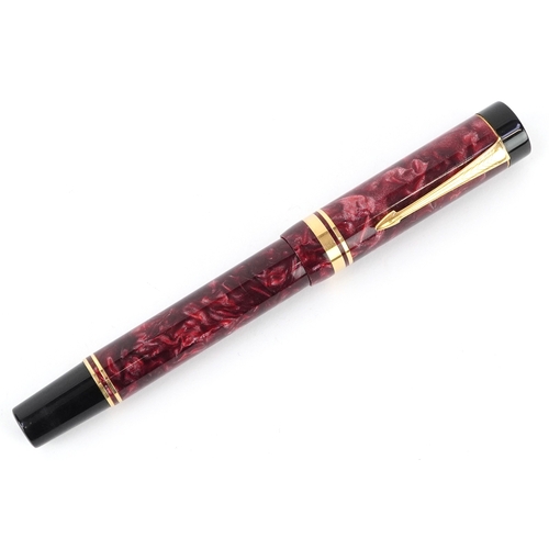 59 - A Parker Duofold red marbleised fountain pen having 18ct gold nib, with box, 13.5cm in length.