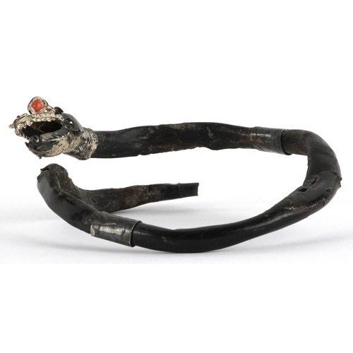 138 - An antique Chinese silver mounted gnarled wood bangle in the form of a dragon with coral eyes, 7.5cm... 