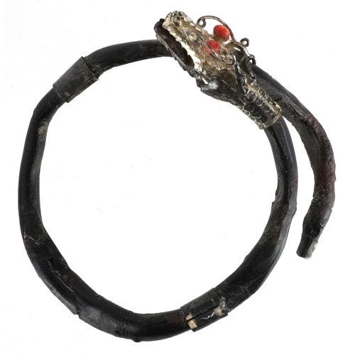 138 - An antique Chinese silver mounted gnarled wood bangle in the form of a dragon with coral eyes, 7.5cm... 