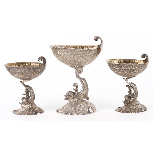 Three silver open salts cast as Putti riding dolphins, with shell design bowls, the largest 15cm high, total 536.3g.