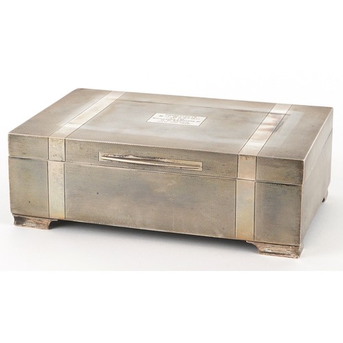 Harrods Ltd., an Art Deco silver mounted engine turned cigar box inscribed Presented to R J Barton by The Managers and Buyers of D H Evans, Jan 17th 1936, London 1934, 20.5cm wide.