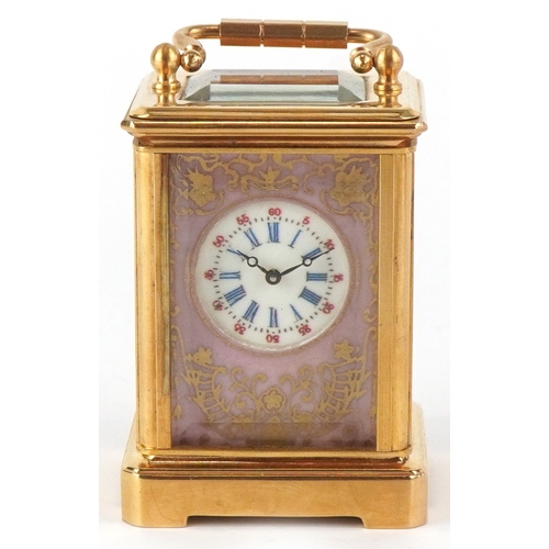 98A - A miniature brass cased carriage clock having Sèvres type panels hand painted with landscapes, the d... 
