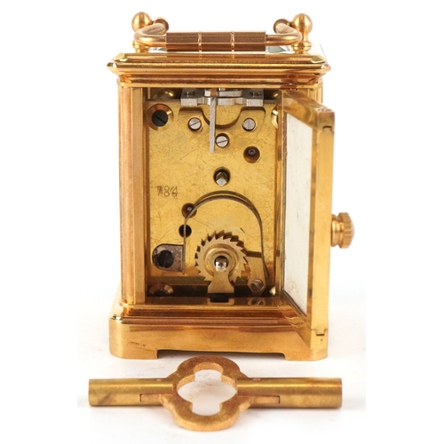 98A - A miniature brass cased carriage clock having Sèvres type panels hand painted with landscapes, the d... 