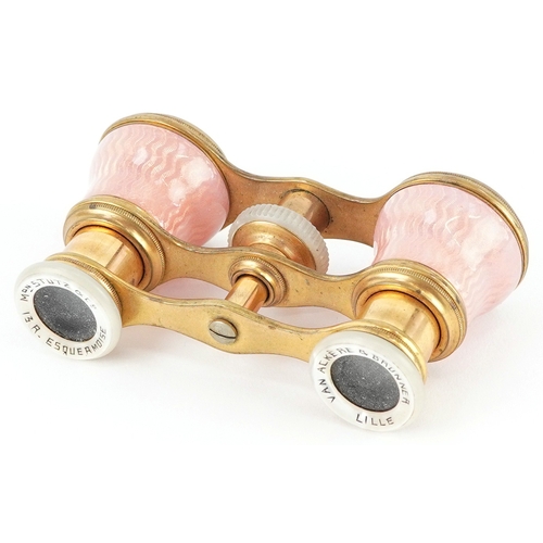 108 - A pair of early 20th century French brass and pink guilloche enamel opera glasses, 9cm wide.
