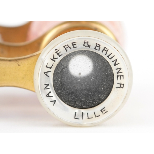 108 - A pair of early 20th century French brass and pink guilloche enamel opera glasses, 9cm wide.