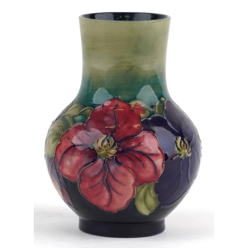 70 - A William Moorcroft pottery vase hand painted in the Clematis pattern, 18cm high.