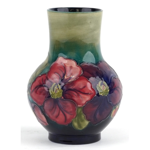 70 - A William Moorcroft pottery vase hand painted in the Clematis pattern, 18cm high.