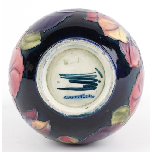 70 - A William Moorcroft pottery vase hand painted in the Clematis pattern, 18cm high.