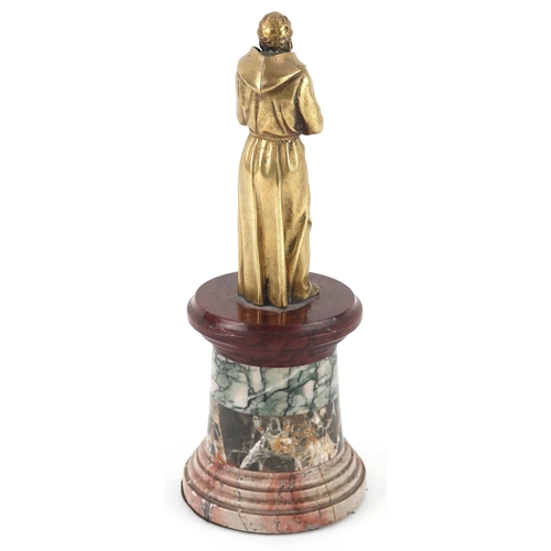  A 19th century gilt bronze figure of a monk raised on a specimen marble pedestal base, 20cm high.