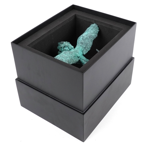 42 - Mark Coreth for McArthur Glen Group, a verdigris bronze figure of a winged lion raised on a black sl... 