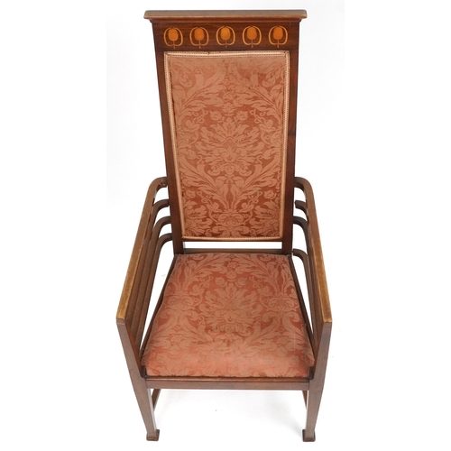  Liberty's Arts & Crafts mahogany high back elbow chair with inlaid decoration, the upholstered drop ... 