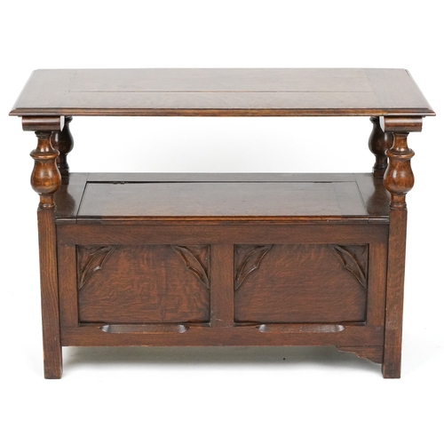  Victorian Gothic Revival oak monk's bench with carved decoration, the box seat above a panelled fron... 