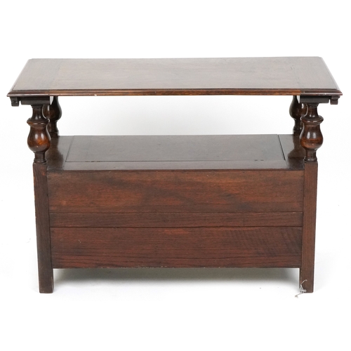  Victorian Gothic Revival oak monk's bench with carved decoration, the box seat above a panelled fron... 