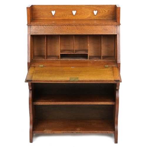  Liberty's Arts & Crafts oak student's bureau with chequer stringing and pierced decoration, the fall... 