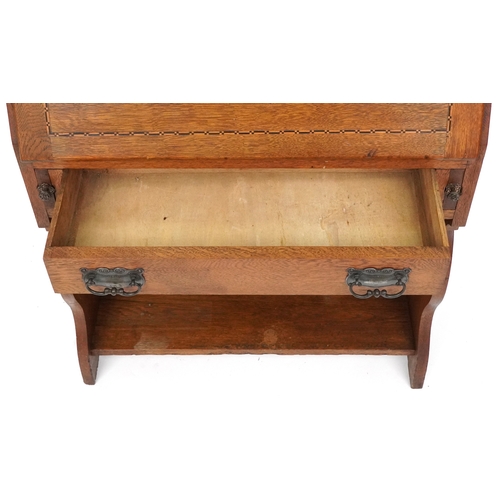  Liberty's Arts & Crafts oak student's bureau with chequer stringing and pierced decoration, the fall... 
