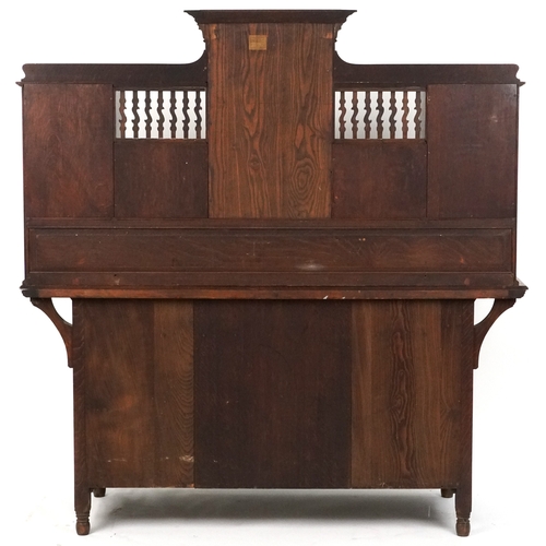  Shapland and Petter an Arts & Crafts oak sideboard with inlaid floral decoration, the dental moulded... 