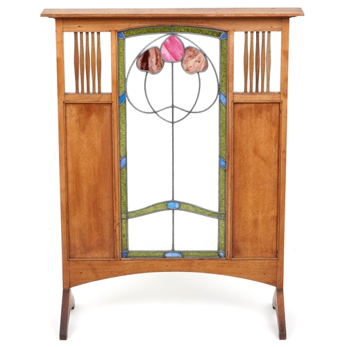  Arts & Crafts oak framed fire screen inset with a leaded stained glass central panel flanked by copp... 