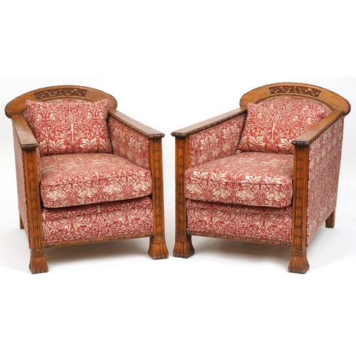  Pair of Arts & Crafts oak framed armchairs with carved decoration, upholstered in Arts & Crafts styl... 
