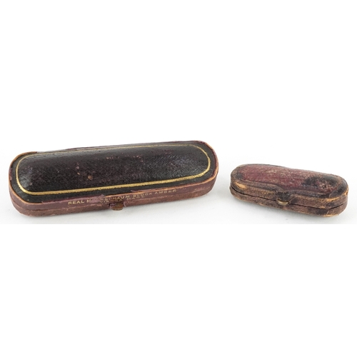 103 - A Meerschaum cheroot holder with amber coloured mouthpiece and silver collar together with an 18ct g... 