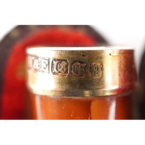 103 - A Meerschaum cheroot holder with amber coloured mouthpiece and silver collar together with an 18ct g... 