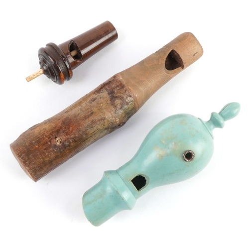 Three vintage wooden whistles including two bird call whistles, the ...