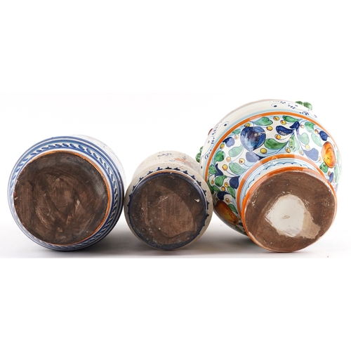 21 - Three Majolica apothecary jars, the largest 38cm high.