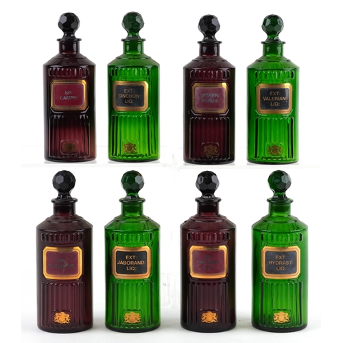 84 - A collection of Royal Pharmaceutical Society coloured glass chemist bottles with facetted stoppers, ... 
