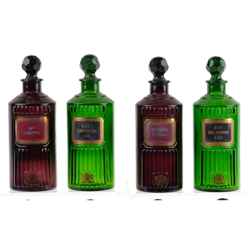 84 - A collection of Royal Pharmaceutical Society coloured glass chemist bottles with facetted stoppers, ... 