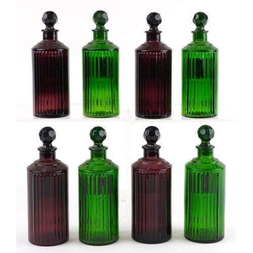 84 - A collection of Royal Pharmaceutical Society coloured glass chemist bottles with facetted stoppers, ... 