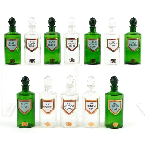 85 - A collection of Royal Pharmaceutical Society coloured glass chemist bottles with facetted stoppers, ... 