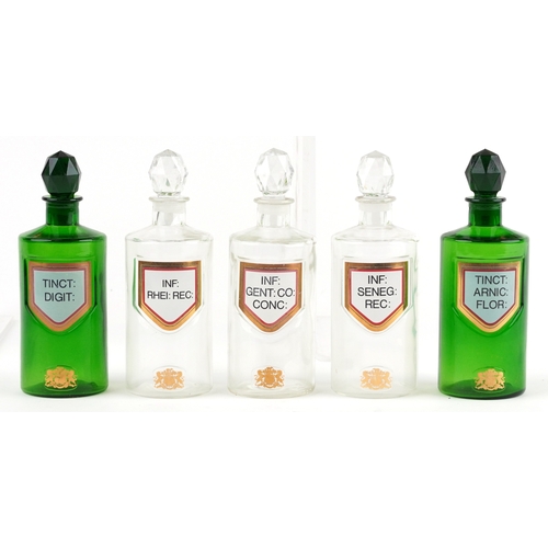 85 - A collection of Royal Pharmaceutical Society coloured glass chemist bottles with facetted stoppers, ... 