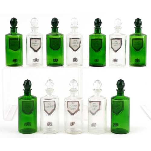 85 - A collection of Royal Pharmaceutical Society coloured glass chemist bottles with facetted stoppers, ... 