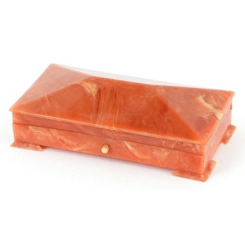 104 - An Art Deco Bakelite jewel box with velvet lining, 9cm wide.