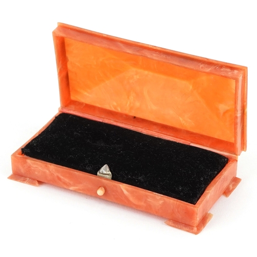 104 - An Art Deco Bakelite jewel box with velvet lining, 9cm wide.