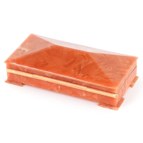 104 - An Art Deco Bakelite jewel box with velvet lining, 9cm wide.